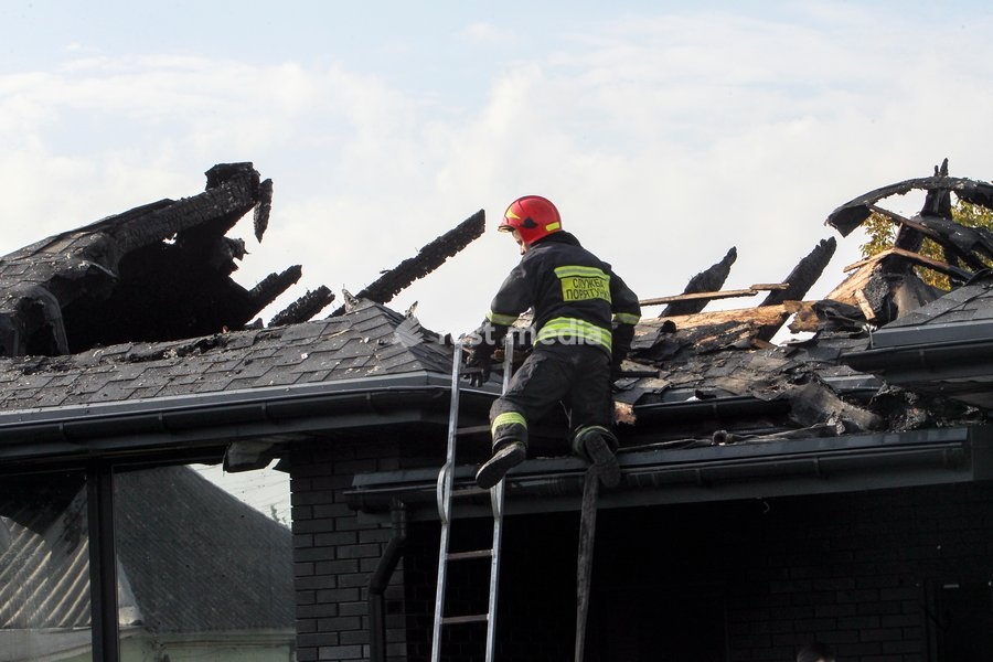 A rescuer goes down a ladder during a response effort to a Russian attack on a residential area in Dnipro, Ukraine, October 22, 2026. According to city head Borys Filatov, 11 private houses were damaged in the strike on Thursday morning, and one home burned down completely