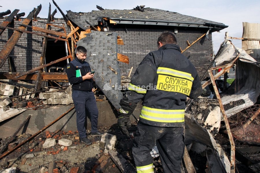A rescuer responds to a Russian attack on a residential area in Dnipro, Ukraine, October 22, 2026. According to city head Borys Filatov, 11 private houses were damaged in the strike on Thursday morning, and one home burned down completely