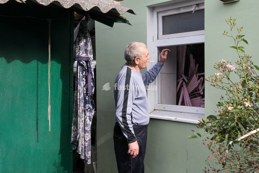 A man smoking a cigarette looks at a shattered window in a house after a Russian attack on a residential area in Dnipro, Ukraine, October 22, 2026. According to city head Borys Filatov, 11 private houses were damaged in the strike on Thursday morning, and one home burned down completely