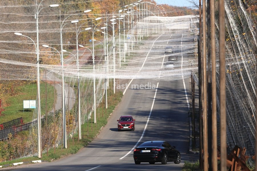 Cars drive along a road covered with an anti-drone net, Kharkiv, Ukraine, October 24, 2026. Anti-drone nets are being installed to protect civilians and vehicles from Russian UAV strikes