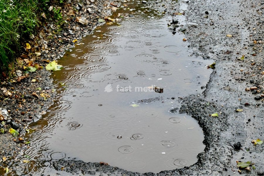 A pot hole filled with rain water