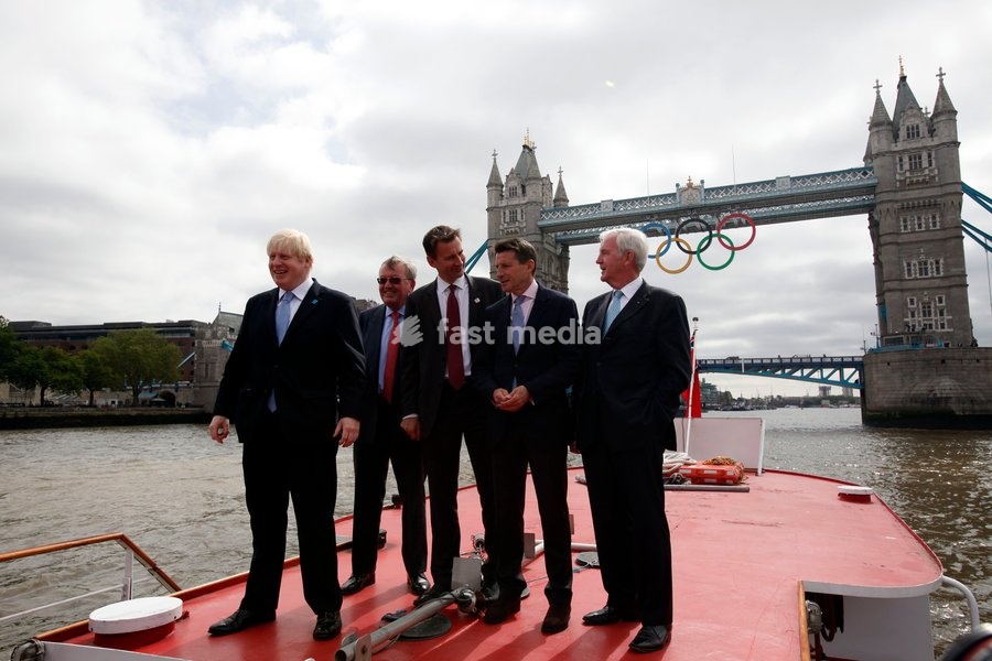 Mayor of London Boris Johnson (C) Lord Sebastian Coe, The Chair of the London Organising Committee of the Olympic Games and British Culture Secretary (R)Jeremy Hunt (L), poss for a photograph as a giant set of Olympic rings are displayed from Tower Bridge on June 27, 2012 in London, England. The…