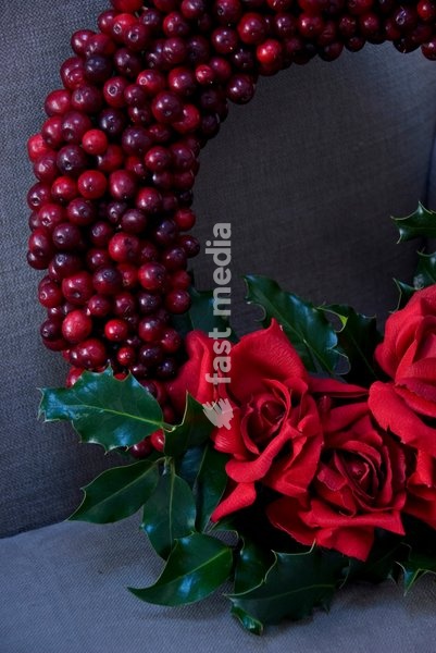 Red Christmas wreath decorated with roses and berries