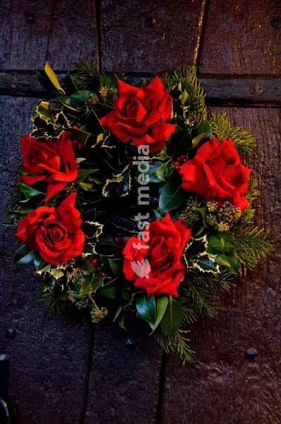 Christmas wreath decorated with red roses