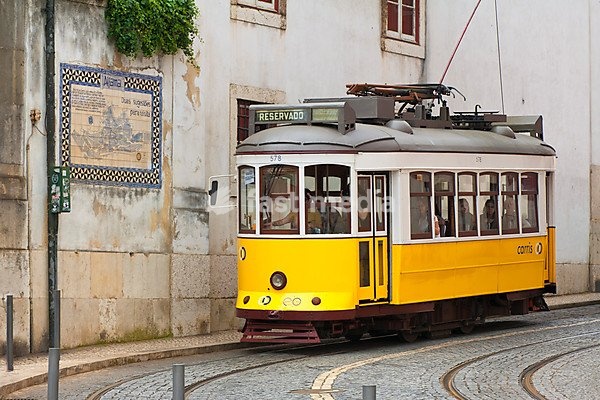 Tram in a street in Alfama district, Lisbon, Portugal, Europe