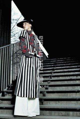 Fashion: Women's fashion, France / Photo, 1960s. Model standing on a staircase, Paris. Photo, undated