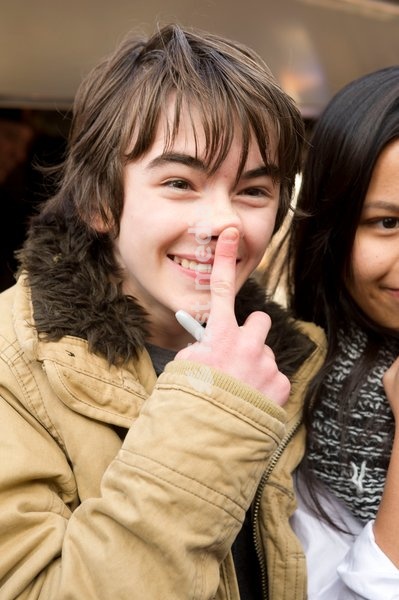 Isaac Hempstead Wright who plays Bran Stark in the series Game of Thrones by the Game of Thrones Westeros Food Wagon to celebrate the release of Season Two on DVD and Blu-ray, Tottenham Court Road.,London