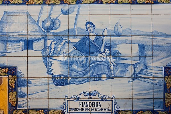 Azulejo, mural made of ceramic tiles, woman holding a spindle, in Funchal