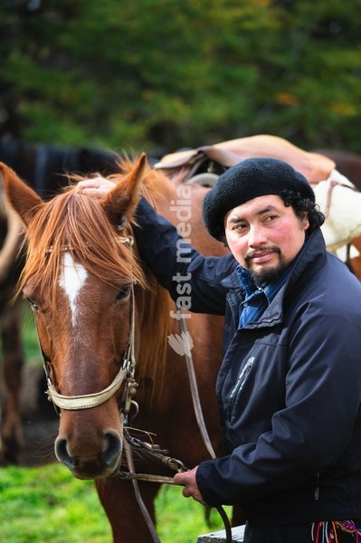 Gaucho getting read to mount his horse.Patagonia. Chile