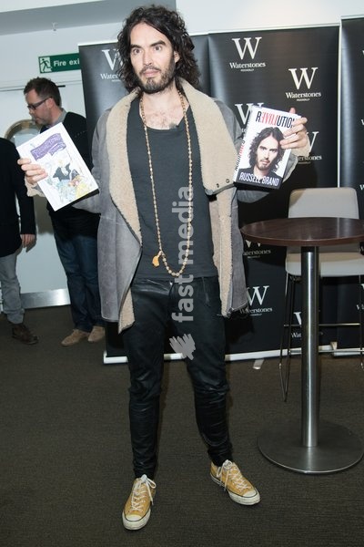Comedian Russell Brand signs copies of his books 'Revolution' and 'The Pied Piper Of Hamelin' at Waterstones Piccadlly, London, England, UK on Friday 5th December 2014