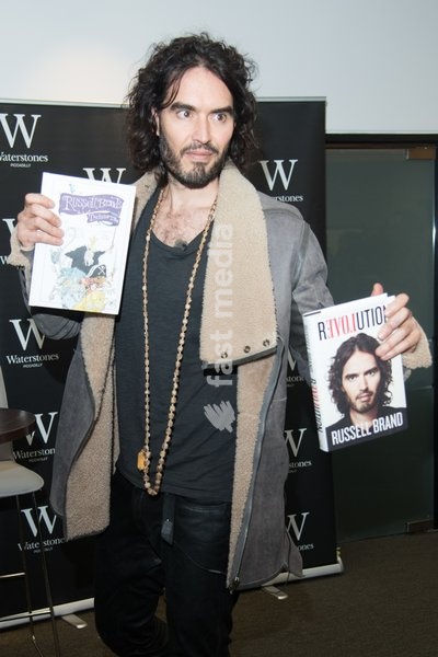 Comedian Russell Brand signs copies of his books 'Revolution' and 'The Pied Piper Of Hamelin' at Waterstones Piccadlly, London, England, UK on Friday 5th December 2014