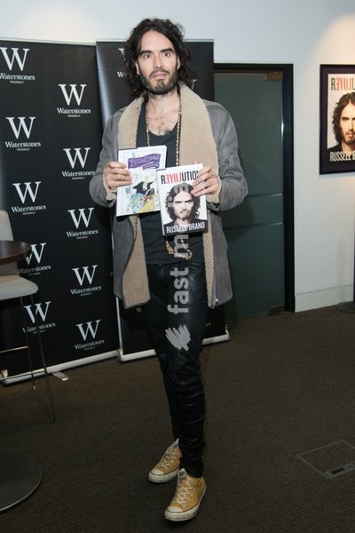 Comedian Russell Brand signs copies of his books 'Revolution' and 'The Pied Piper Of Hamelin' at Waterstones Piccadlly, London, England, UK on Friday 5th December 2014