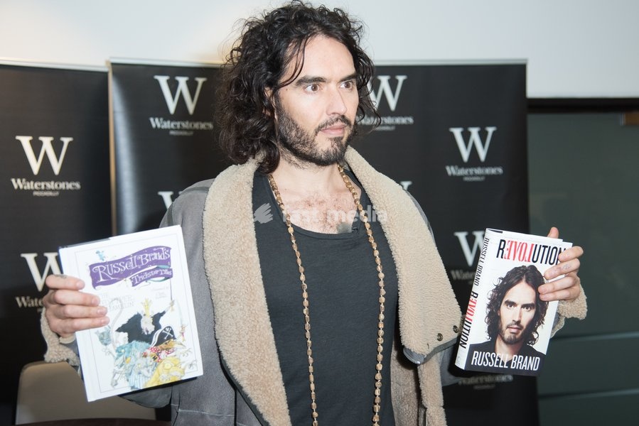 Comedian Russell Brand signs copies of his books 'Revolution' and 'The Pied Piper Of Hamelin' at Waterstones Piccadlly, London, England, UK on Friday 5th December 2014
