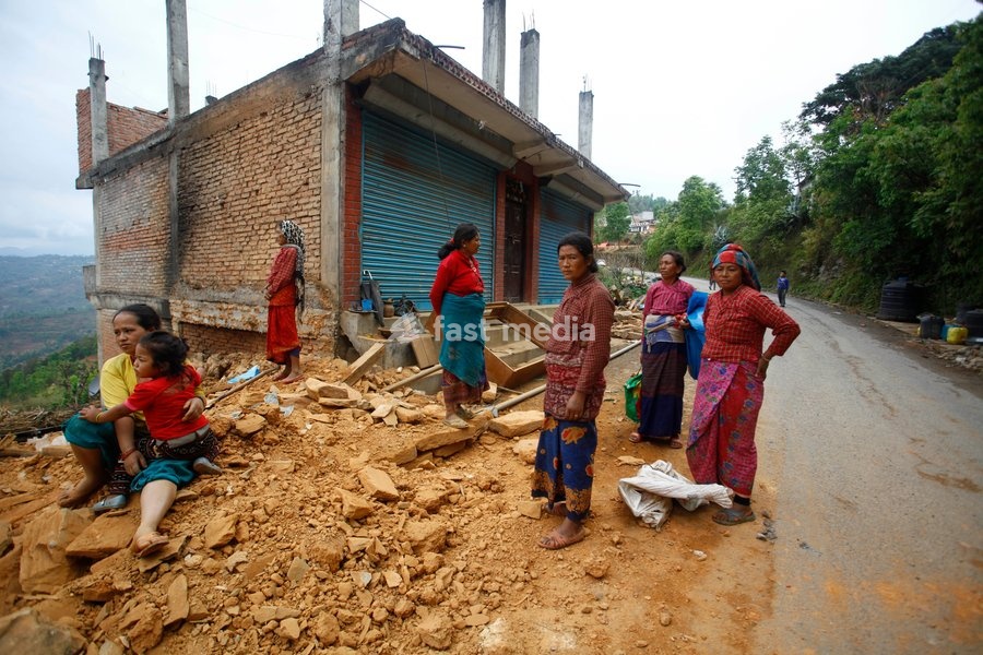 (150429) -- SINDHUPALCHOWK, April 29, 2015 () -- People gather near destructed houses after earthquake at Sindhupalchowk district, Nepal, April 29, 2015. By noon on Wednesday, more than 1,376 people had already been confirmed dead in Sindhupalchowk district alone, some 100 km away from the capital…