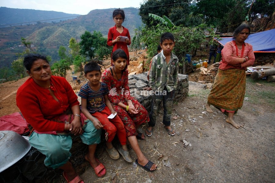 (150429) -- SINDHUPALCHOWK, April 29, 2015 () -- People gather near destructed houses after earthquake at Sindhupalchowk district, Nepal, April 29, 2015. By noon on Wednesday, more than 1,376 people had already been confirmed dead in Sindhupalchowk district alone, some 100 km away from the capital…
