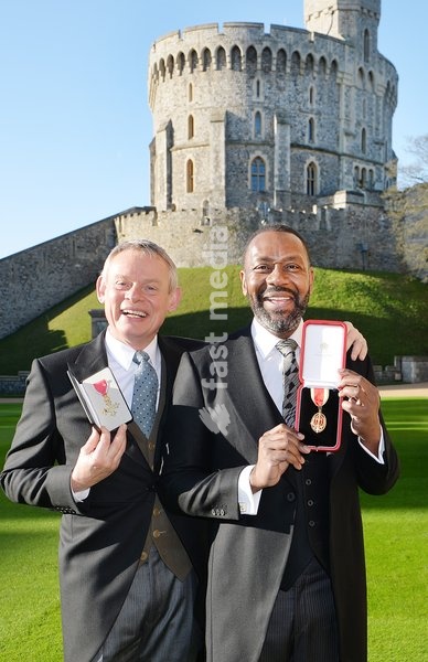 Martin Clunes (left) after receiving an Officer of the Order of the British Empire (OBE) and Sir Lenny Henry who received a Knighthood from Queen Elizabeth II during an Investiture ceremony at Windsor Castle