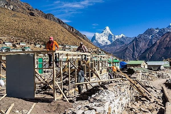 Reconstruction of the houses destroyed by the earthquake in 2015, Ama Dablam (6856m) mountain in the distance, Khumjung, Solo Khumbu, Nepal