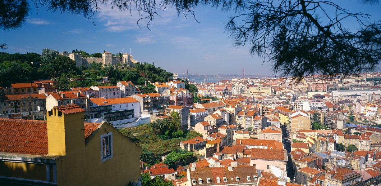 Panoramic city view with St. George's Castle, River Tagus and 25th April Bridge behind
