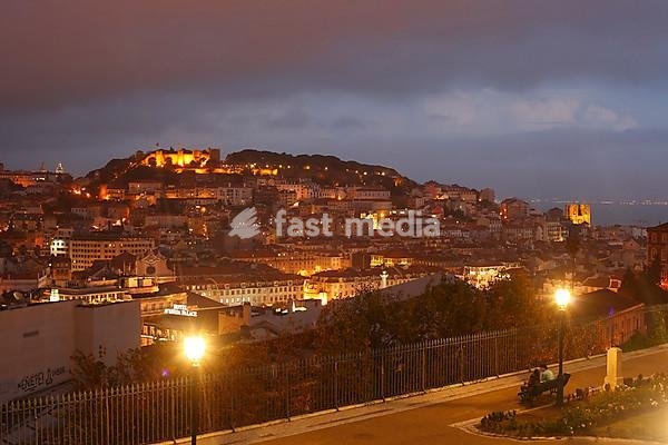View from Miradouro Sao Pedro de Alcantara on the Alfama, Baixa and Castelo Sao Jorge districts at dusk, Lisbon, Portugal