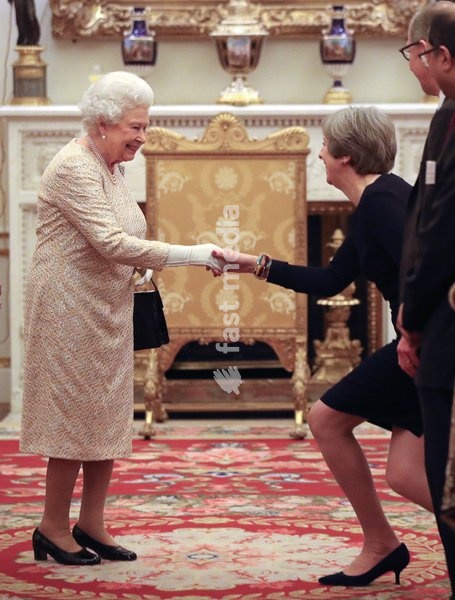 Queen Elizabeth II greets Prime Minister Theresa May at a reception to celebrate the Commonwealth Diaspora community, in the lead up to the Commonwealth Heads of Government meeting in London this April, at Buckingham Palace, London