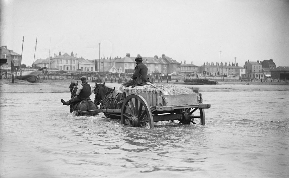 Shoreham harbour, Shoreham-by-Sea, West Sussex, 1905-1925. A partly submerged horse-drawn ballast cart in the sea off Shoreham