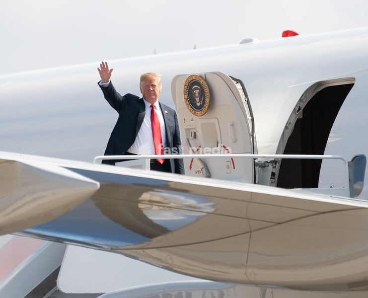 United States President Donald J. Trump waves to the press as he boards Air Force One at Joint Base Andrews, Maryland, en route to events in Illinois, Missouri and Iowa, July 26, 2018