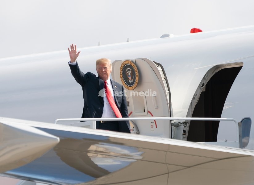 United States President Donald J. Trump waves to the press as he boards Air Force One at Joint Base Andrews, Maryland, en route to events in Illinois, Missouri and Iowa, July 26, 2018