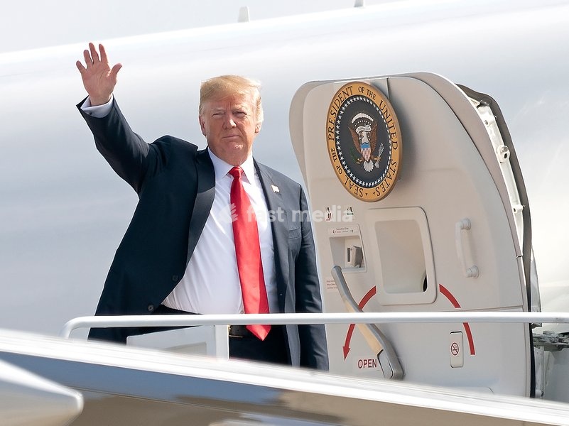 United States President Donald J. Trump waves to the press as he boards Air Force One at Joint Base Andrews, Maryland, en route to events in Illinois, Missouri and Iowa, July 26, 2018