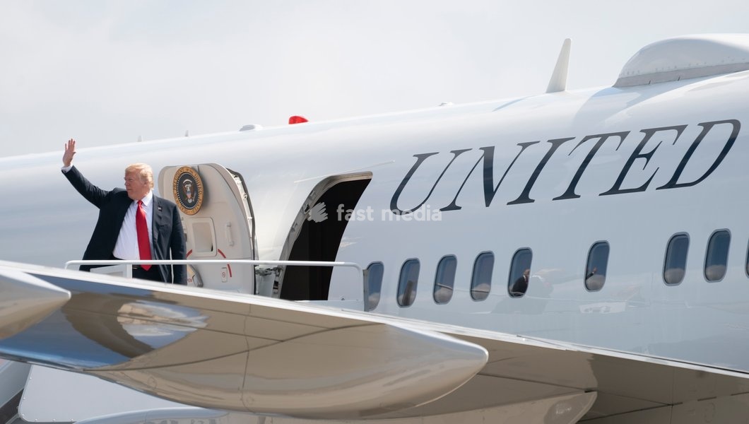 United States President Donald J. Trump waves as he boards Air Force One at Joint Base Andrews, Maryland, en route to events in Illinois, Missouri and Iowa, July 26, 2018