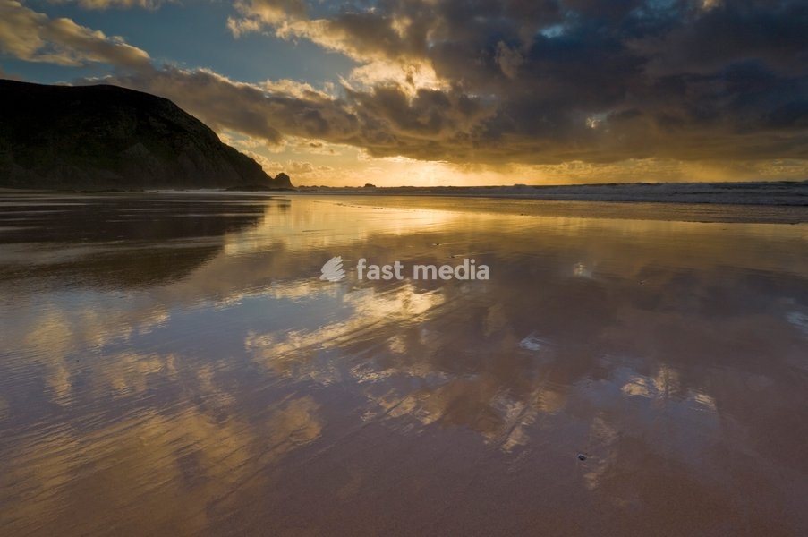 Sunset reflected in tidal wash, Praia do Castelejo beach near Vila do Bispo, Algarve, Portugal, Europe