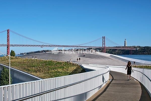 View from the pedestrian bridge to the roof of the museum MAAT, Museu de Arte, Arquitetura e Tecnologia, at the Rio Tejo, behind bridge Ponte 25 de Abril, Belem, Lisbon, Portugal