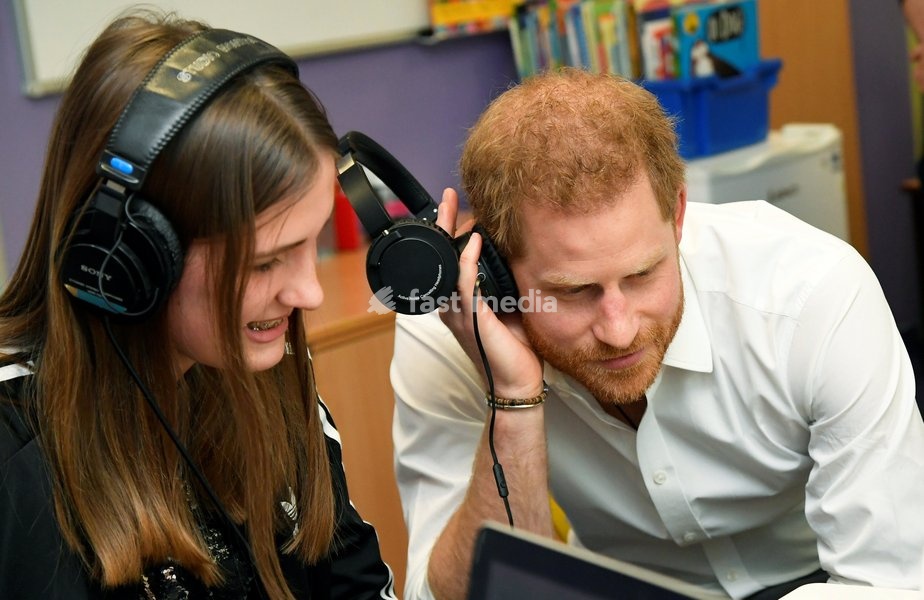 Britain's Prince Harry, Duke of Sussex, listens to the music with Esme, partially made by her, as he visits Oxford Children's Hospital in Oxford, Britain, May 14, 2019