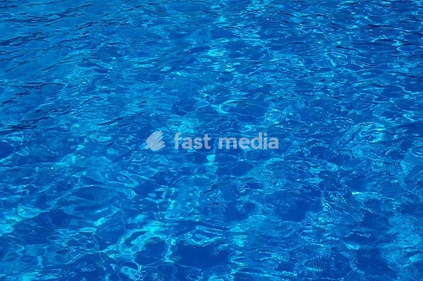 Blue, clear and wavy water in an outdoor pool