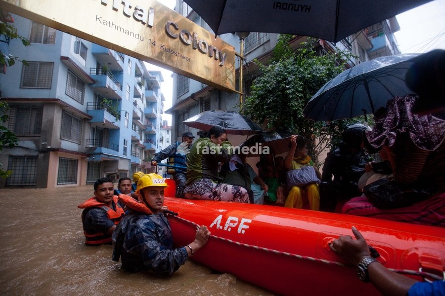 (190712) -- KATHMANDU, July 12, 2019 () -- Nepalese army personnel rescue local people after a heavy rainfall in Kathmandu, Nepal, July 12, 2019. Nepal was hit by heavy rainfall that caused floods and landslides in many places