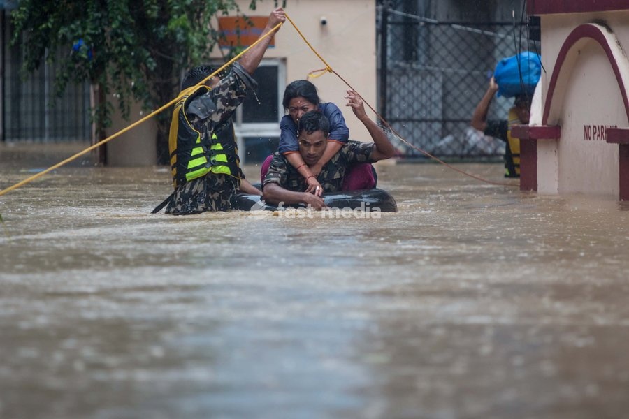 (190712) -- KATHMANDU, July 12, 2019 () -- Nepalese army personnel rescue local people after a heavy rainfall in Kathmandu, Nepal, July 12, 2019. Nepal was hit by heavy rainfall that caused floods and landslides in many places