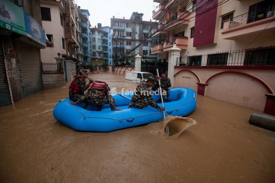 (190712) -- KATHMANDU, July 12, 2019 () -- Nepalese army personnel rescue local people after a heavy rainfall in Kathmandu, Nepal, July 12, 2019. Nepal was hit by heavy rainfall that caused floods and landslides in many places