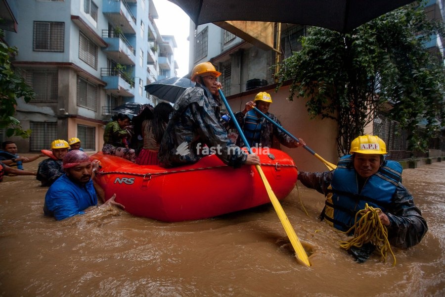 (190712) -- KATHMANDU, July 12, 2019 () -- Nepalese army personnel rescue local people after a heavy rainfall in Kathmandu, Nepal, July 12, 2019. Nepal was hit by heavy rainfall that caused floods and landslides in many places