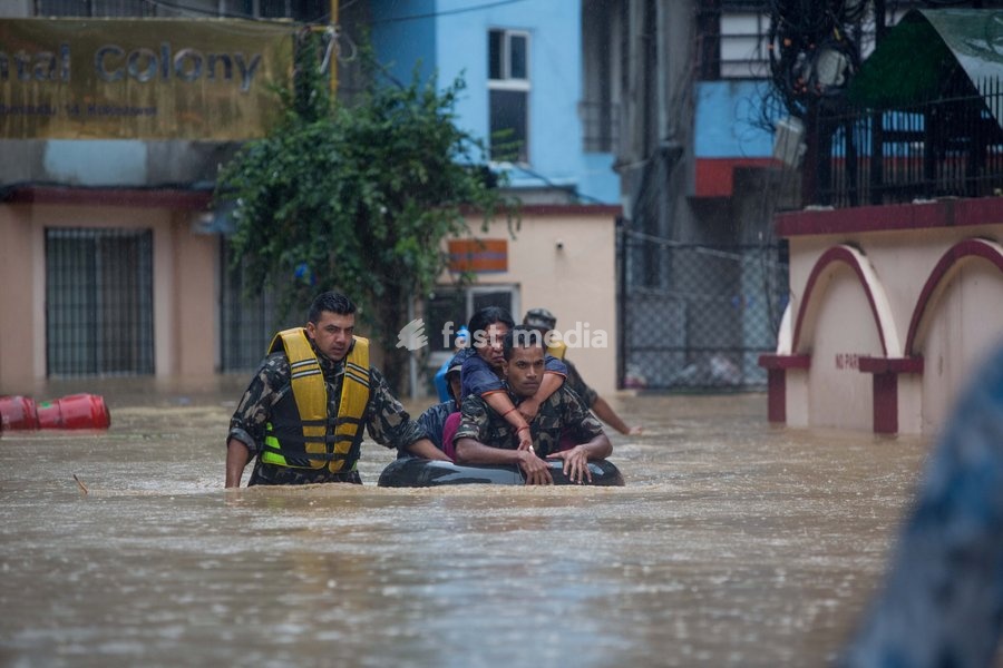 (190712) -- KATHMANDU, July 12, 2019 () -- Nepalese army personnel rescue local people after a heavy rainfall in Kathmandu, Nepal, July 12, 2019. Nepal was hit by heavy rainfall that caused floods and landslides in many places