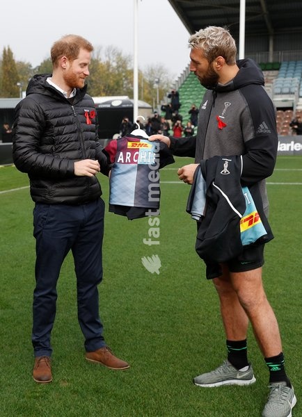 Harlequins Captain Chris Robshaw gives Britain's Prince Harry, Duke of Sussex, a small rugby shirt for baby Archie at the Twickenham Stoop in London, Britain November 8, 2019