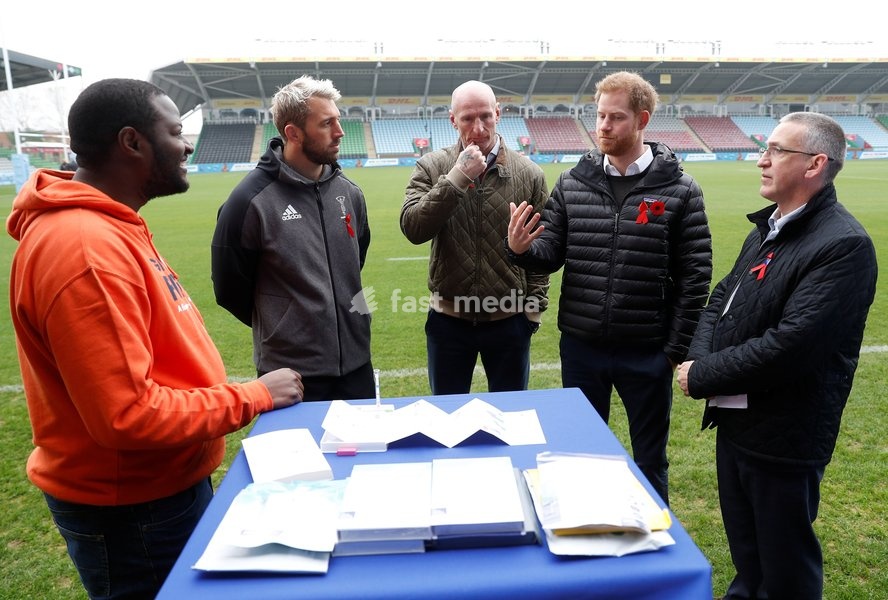 Britain's Prince Harry, Duke of Sussex, speaks in front of a display of testing kits, next to former rugby player Gareth Thomas, Harlequins Captain Chris Robshaw, and Ian Green, CEO of the Terence Higgins Trust, during a visit to the Twickenham Stoop in London, Britain November 8, 2019