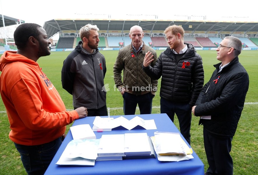 Britain's Prince Harry, Duke of Sussex, speaks in front of a display of testing kits, next to former rugby player Gareth Thomas, Harlequins Captain Chris Robshaw, and Ian Green, CEO of the Terence Higgins Trust, during a visit to the Twickenham Stoop in London, Britain November 8, 2019