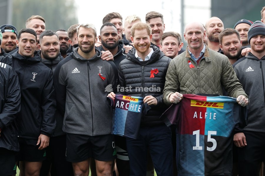 Britain's Prince Harry, Duke of Sussex, and former rugby player Gareth Thomas pose with gift shirts next to Harlequin rugby club members and their captain Chris Robshaw during a visit to the Twickenham Stoop in London, Britain November 8, 2019