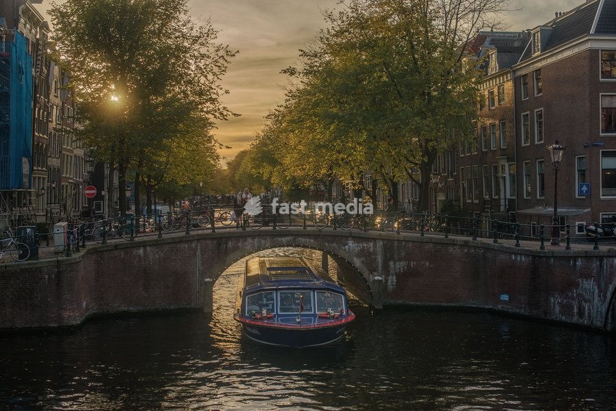 A sightseeing boat on a canal in Amsterdam, The Netherlands