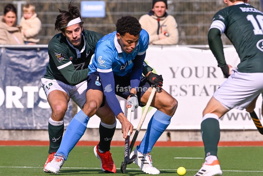 Watduck's Nicolas Dumont and Braxgata's Nelson Onana Alima fight for the ball during a hockey game between Waterloo Ducks HC and Braxgata, Sunday 06 March 2022 in Waterloo, on the 14th day of the men's Belgian League season 2021-2022