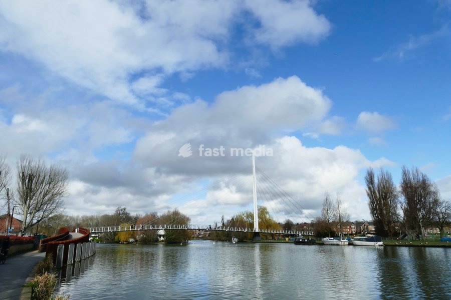 People by Christchurch Meadows on a sunny morning by The River Thames