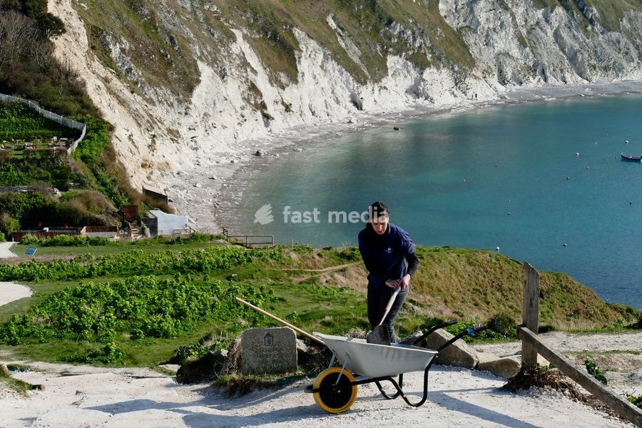 A Lulworth Ranger tidy’s the coast paths ready for the days visitors