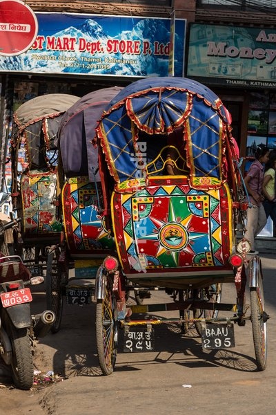 Colorfully painted bicycle rickshaws parked on the street in Thamel, Kathmandu, Nepal