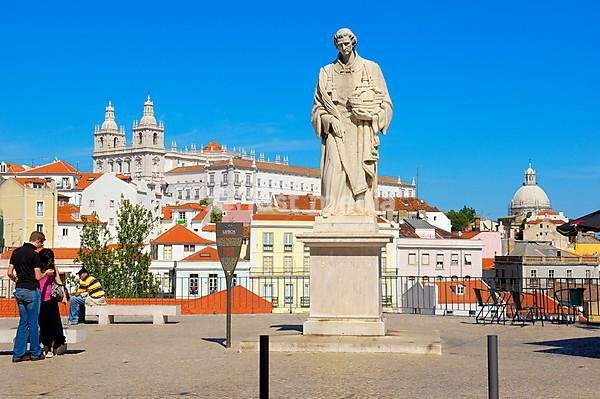 Lisbon, Sao Vicente de Fora statue and Sao Vicente de Fora church from Largo das Portas do Sol viewpoint, Alfama district, Portugal