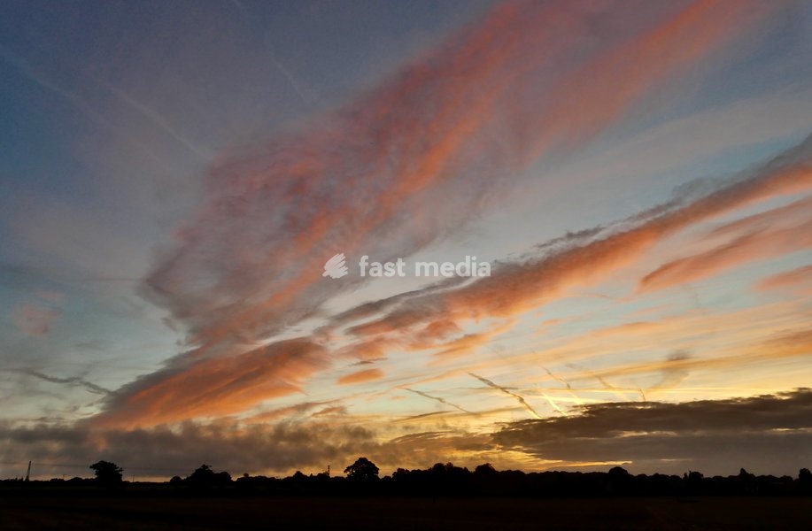 Pretty skies at daybreak as the sun rises over the countryside