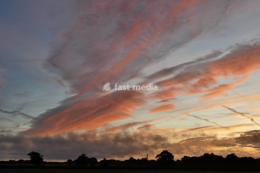 Pretty skies at daybreak as the sun rises over the countryside